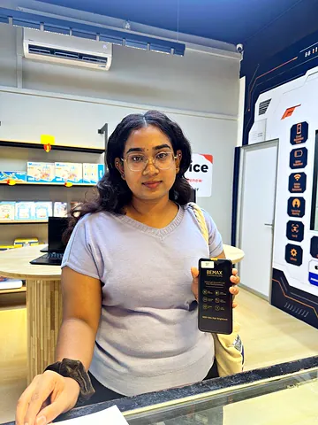 Customer in glasses holding a replacement screen pack at the counter